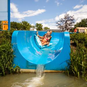 a woman and a child on a water slide at Vakantiepark de Witte Berg in Ootmarsum