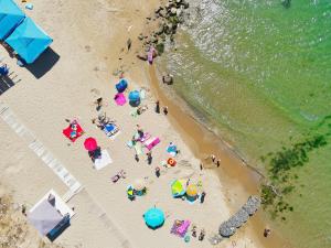 an overhead view of a beach with people and umbrellas at Privilege Fort Beach Apartments in Sveti Vlas +61 photos