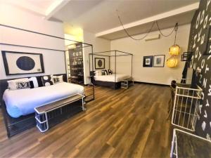 a bedroom with two beds and a wooden floor at M Boutique Hotel Station 18 - Ipoh in Ipoh +89 photos