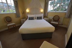 Postel nebo postele na pokoji v ubytování Hunters Moon Hotel