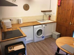 a kitchen with a washing machine and a sink at Yairbrig Holiday in Galashiels