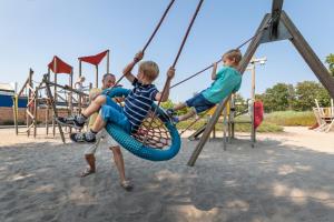 three young boys playing on a playground at Europarcs Zuiderzee in Biddinghuizen