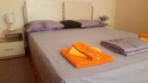 a bed with two towels sitting on top of it at Central Apartment in Silistra