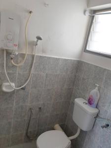 a bathroom with a shower and a toilet in it at Kinora Homestay in Perai