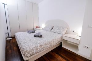 a bedroom with a bed with shoes on it at Downtown Como-Porta Torre Flat in Como