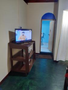 a room with a television on a table with a mirror at ChandraSobana in Nuwara Eliya