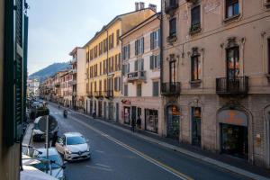 a car parked on a city street with buildings at Downtown Como-Porta Torre Flat in Como