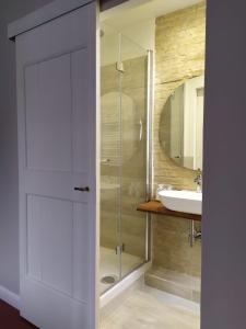 a bathroom with a glass shower and a sink at B&B Suite 44 in Pesaro