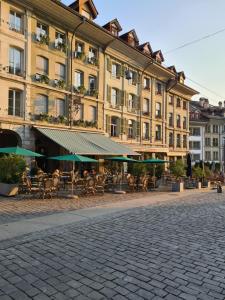 a building with tables and chairs in front of a building at Boutique Hotel Belle Epoque in Bern