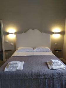 a bedroom with a bed with two towels on it at B&B Suite 44 in Pesaro