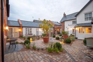 a courtyard of a house with a brick yard at The Lion at Malpas in Malpas