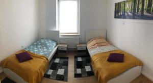 Duas camas num pequeno quarto com uma janela em Zimmervervietung Bei Lachajczyk em Bad Salzdetfurth