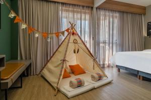 Cama ou camas em um quarto em Grand Mercure SP Itaim Bibi