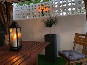 a patio with a table and a candle and a candle at Lilo 30, Only Families, Puy du Fou in Olías del Rey