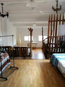 a living room with a bed and a wooden floor at CALANURI in García