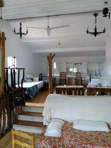 a room with two beds and a table and chairs at CALANURI in García