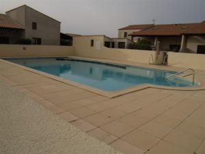 a swimming pool with blue water in a house at Stephanie Immobilier in Saintes-Maries-de-la-Mer