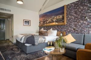 a bedroom with a bed and a brick wall at Abel Heywood Boutique Hotel in Manchester