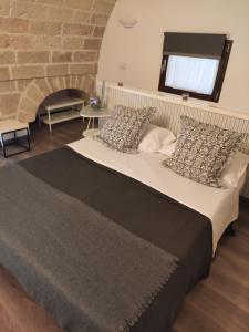 a large bed in a room with a brick wall at B&B Sant'Anna in Bari
