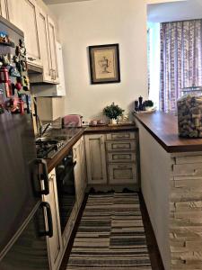 a kitchen with white cabinets and a counter top at Vintage touch apartment in Cluj-Napoca