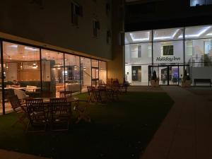 a group of tables and chairs in front of a building at Holiday Inn Sittingbourne, an IHG Hotel in Sittingbourne