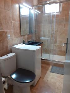 a bathroom with a toilet and a sink and a shower at RESIDENCE PORTO DI MAR CAVALAIRE in Cavalaire-sur-Mer