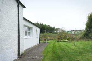 a side view of a house with a yard at The Lodge House Callander in Callander