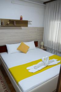 a bedroom with a bed with two white towels on it at Apartment Elmari in Prilep