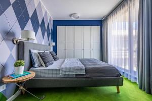 a bedroom with a bed and a table at The Golfer Apartment with Jacuzzi in Cluj-Napoca