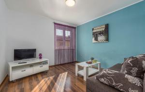 a living room with a couch and a tv at Apartment Marino in Poreč