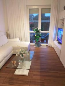 a living room with a white couch and a table at Sesto Calende Centro in Sesto Calende +25 photos