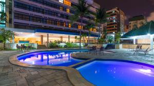 a swimming pool in the middle of a building at Aram Beach & Convention in João Pessoa