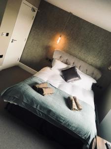 a bedroom with a bed with two towels on it at The Station Restaurant & Bar in Doncaster