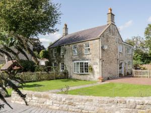 an old stone house with a garden in front of it at Crooked Well in Bath