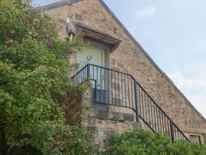 a staircase leading up to a white door on a building at The Coach House in Pembroke