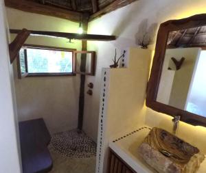 a bathroom with a mirror and a sink at Tulum Nueve in Tulum