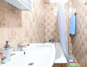 a bathroom with a white sink and a tub at Apartment Rustic Oporto in Porto +58 photos