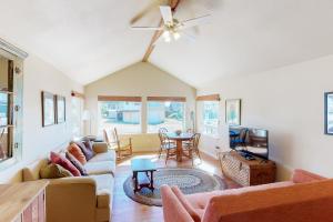 a living room with a couch and a table at Beach Cabin Getaway in Rockaway Beach