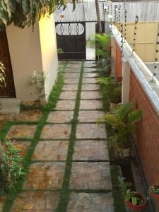 a stone walkway in front of a building at Jfour comfort zone hostel in Dar es Salaam