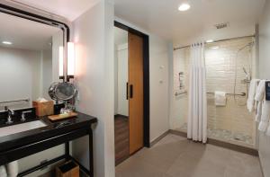 a bathroom with a sink and a shower at The Beeman Hotel in Dallas