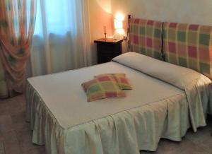 Postel nebo postele na pokoji v ubytování Agriturismo Il Cavallino Saturnia