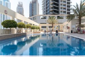 a swimming pool in the middle of a building with tall buildings at GuestReady - Brown Sugar in Dubai