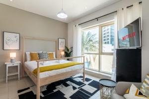 a bedroom with a bed and a large window at GuestReady - Brown Sugar in Dubai