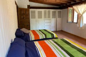 a bedroom with two beds in a room at Casa Atardecer Valle de Bravo in Valle de Bravo
