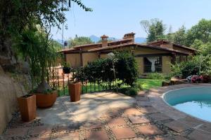 een achtertuin met een zwembad en een huis bij Casa Atardecer Valle de Bravo in Valle de Bravo