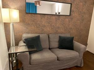 a living room with a couch and a lamp at B&B by the C in Vlissingen
