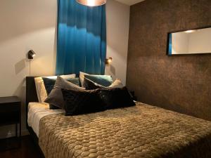 a bedroom with a large bed and a large window at B&B by the C in Vlissingen