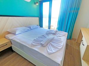 a bedroom with a bed with a bow on it at Yeshill Boutique Hotel in Marmaris