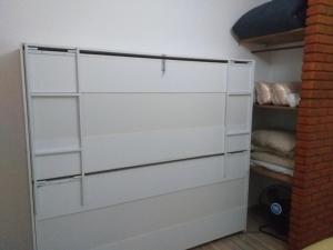 a closet with white doors in a room at Recanto das Termas, Chalés in Termas do Ibirá