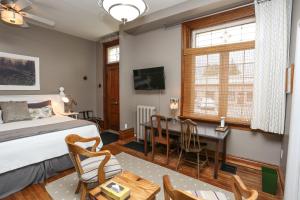 a bedroom with a bed and a desk and a table at Danby House in Markdale